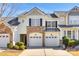 Inviting townhome boasts a stone facade, two-car garage, and manicured landscaping at 510 Pine Links Dr, Tega Cay, SC 29708