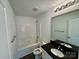 Bathroom features a black countertop, large mirror, and a shower-tub combination at 514 Meadowrock Dr, Albemarle, NC 28001