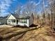 Charming single-story home with white siding, a gray roof, and a spacious yard in a wooded neighborhood at 514 Meadowrock Dr, Albemarle, NC 28001