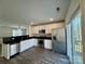 Bright kitchen featuring stainless steel appliances, white cabinets, dark countertops, and access to a wooden deck at 514 Meadowrock Dr, Albemarle, NC 28001