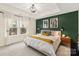 Serene bedroom with modern decor, a tray ceiling, and large windows for natural light at 613 Tudor Park Way, Charlotte, NC 28211