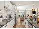 Modern kitchen with white cabinets, stainless steel appliances, and an open view to the living area at 613 Tudor Park Way, Charlotte, NC 28211