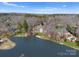 Expansive waterfront estate with a large home, private pool, and lush surroundings viewed from above at 706 Eagle Point Ct, Weddington, NC 28104