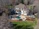 Aerial view of backyard oasis with pool, hot tub, fire pit, patio, and balcony at 706 Eagle Point Ct, Weddington, NC 28104