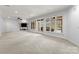 Expansive carpeted basement with built-ins, recessed lighting, and access to backyard and pool at 706 Eagle Point Ct, Weddington, NC 28104