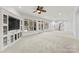 Spacious basement living area with carpet, built-in shelving, and large windows at 706 Eagle Point Ct, Weddington, NC 28104