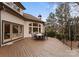 Large wooden deck with outdoor seating area offering views of the wooded backyard and home at 706 Eagle Point Ct, Weddington, NC 28104