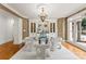Refined dining room with a glass table, elegant chandelier, and built-in cabinets for sophisticated living at 706 Eagle Point Ct, Weddington, NC 28104