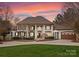 Grand two-story home with manicured lawn and circular driveway, perfect for luxury living at 706 Eagle Point Ct, Weddington, NC 28104