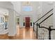 Grand foyer featuring hardwood floors, staircase, chandelier, and a front door framed by sidelights and a transom window at 706 Eagle Point Ct, Weddington, NC 28104