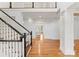 Elegant foyer featuring hardwood floors, a staircase with white railings, and an open view to the living area at 706 Eagle Point Ct, Weddington, NC 28104