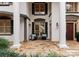 Inviting front porch with stone flooring, comfortable seating, and elegant exterior lighting fixtures at 706 Eagle Point Ct, Weddington, NC 28104