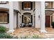 Charming front porch with stone flooring, comfortable seating, and elegant architectural details at 706 Eagle Point Ct, Weddington, NC 28104