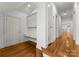 Hallway with hardwood floors, white trim, and built-in desk and cabinets at 706 Eagle Point Ct, Weddington, NC 28104