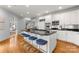 Kitchen with an island with seating, stainless steel appliances, and hardwood floors at 706 Eagle Point Ct, Weddington, NC 28104