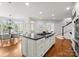 Open-concept kitchen featuring a large island with a cooktop, adjacent to a dining area at 706 Eagle Point Ct, Weddington, NC 28104
