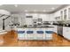 Spacious kitchen with white cabinets, black countertops, stainless steel appliances, and a large island at 706 Eagle Point Ct, Weddington, NC 28104