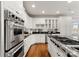 Chef's kitchen featuring stainless appliances, black countertops, and ample white cabinetry at 706 Eagle Point Ct, Weddington, NC 28104