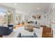 Bright living room with large windows, hardwood floors, and stylish furniture, perfect for relaxation at 706 Eagle Point Ct, Weddington, NC 28104