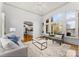 Bright living room with large windows, hardwood floors, and comfortable seating at 706 Eagle Point Ct, Weddington, NC 28104
