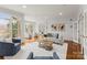 Bright living room with hardwood floors, large windows, and comfortable seating creating a welcoming atmosphere at 706 Eagle Point Ct, Weddington, NC 28104