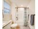 Bright bathroom featuring a shower, granite countertop, and window with white blinds at 711 E 3Rd Ave, Gastonia, NC 28054