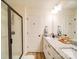 Bathroom with a glass-enclosed shower, double sink vanity with granite countertop, and contemporary lighting at 711 E 3Rd Ave, Gastonia, NC 28054