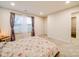 Comfortable bedroom with neutral tones, carpet, and natural light from a large window at 711 E 3Rd Ave, Gastonia, NC 28054