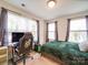 Well-lit bedroom featuring a gaming setup and comfortable bed with natural lighting at 711 E 3Rd Ave, Gastonia, NC 28054