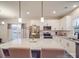 Bright kitchen features a large island with granite countertops, stainless steel appliances, and white cabinetry at 711 E 3Rd Ave, Gastonia, NC 28054