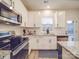 Modern kitchen features stainless appliances, granite countertops, and white cabinets at 711 E 3Rd Ave, Gastonia, NC 28054