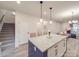 Kitchen island with granite countertop, modern lighting and seating for entertaining at 711 E 3Rd Ave, Gastonia, NC 28054