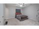 Bedroom with a ceiling fan, window, and orange headboard bed at 7209 Tressel Ln, Mint Hill, NC 28227