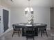 Elegant dining space with modern black furniture and a stylish overhead light fixture at 7209 Tressel Ln, Mint Hill, NC 28227