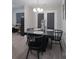 Elegant dining room with modern black furniture and a stylish chandelier at 7209 Tressel Ln, Mint Hill, NC 28227