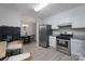 Well-lit kitchen with stainless steel appliances, modern white cabinets, and an open layout at 7209 Tressel Ln, Mint Hill, NC 28227