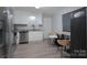 Contemporary kitchen featuring stainless steel appliances, white cabinets, and a granite countertop at 7209 Tressel Ln, Mint Hill, NC 28227