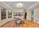 Bright dining area featuring hardwood floors, natural light, and adjacent open kitchen access at 9600 Mersham Ct, Charlotte, NC 28269