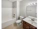 A clean bathroom with a tub-shower combo, vanity sink, white fixtures, and neutral flooring at 111 Charterhouse Ln, Fort Mill, SC 29715