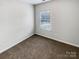 A bright, cozy bedroom features neutral walls, carpet, and a window allowing for natural light at 111 Charterhouse Ln, Fort Mill, SC 29715