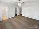 Neutral bedroom with a ceiling fan, carpet, and access to closet and hallway at 111 Charterhouse Ln, Fort Mill, SC 29715