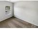 The bedroom is brightly lit with neutral colored walls, carpet, and a window for natural light at 111 Charterhouse Ln, Fort Mill, SC 29715
