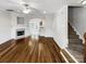 Inviting open-concept living space with hardwood floors, a cozy fireplace, and easy access to the kitchen and stairs at 111 Charterhouse Ln, Fort Mill, SC 29715