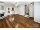 Spacious living room featuring hardwood floors, a fireplace, and a seamless flow to the kitchen and staircase at 111 Charterhouse Ln, Fort Mill, SC 29715