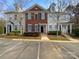 Charming brick townhouse with blue shutters, set in a desirable neighborhood with well-maintained landscaping and ample parking at 111 Charterhouse Ln, Fort Mill, SC 29715