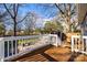 Spacious back deck with white railings overlooks the backyard and cabana, perfect for entertaining at 119 N Smallwood Pl, Charlotte, NC 28216