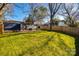 Large, green backyard featuring deck with outdoor seating and wood privacy fence at 119 N Smallwood Pl, Charlotte, NC 28216