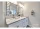 Bright bathroom featuring dual sinks, large mirrors, and modern fixtures at 119 N Smallwood Pl, Charlotte, NC 28216