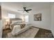 Calm bedroom featuring a ceiling fan, plush bed, and hardwood floors at 119 N Smallwood Pl, Charlotte, NC 28216