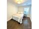 Cozy bedroom features wood floors, a window, and a neutral color scheme at 119 N Smallwood Pl, Charlotte, NC 28216